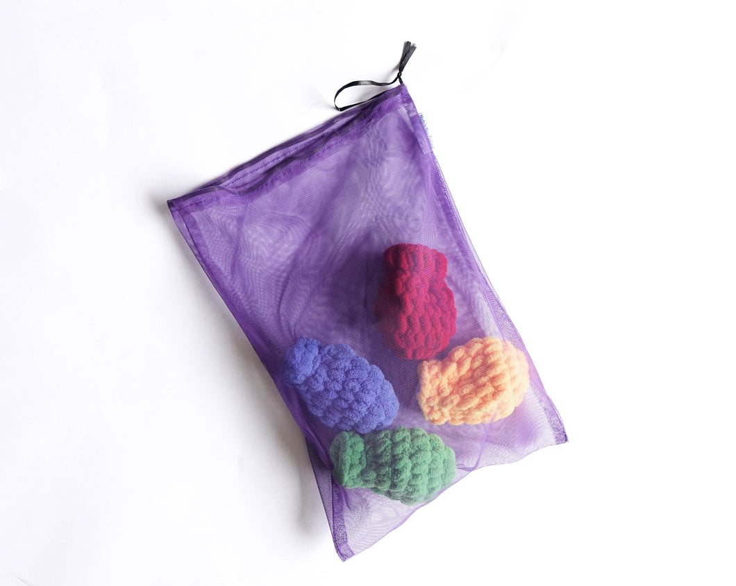 A purple drawstring mesh bag containing four EcoSplat reusable water balloons of different colours: yellow, blue, green, red